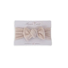Headwrap with bow for baby in Plush Latte fabric styles.