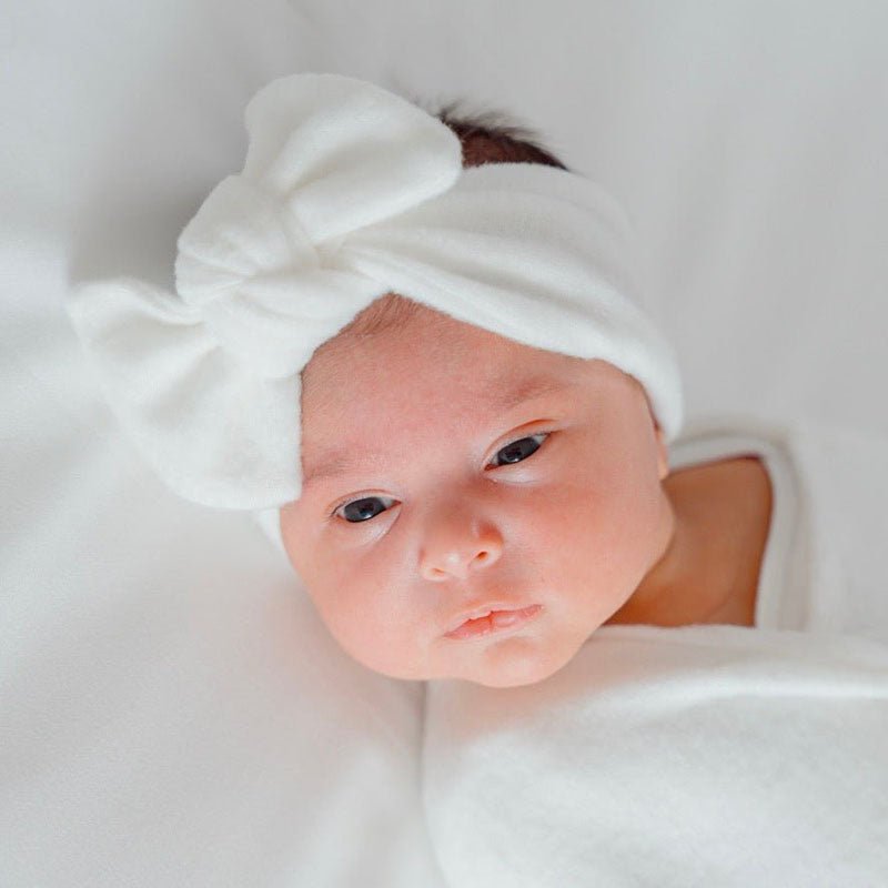 Baby headwrap with bow crafted in soft Plush Perfection fabric.