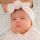 Baby headwrap with bow crafted in soft Plush Pink Cashmere fabric.