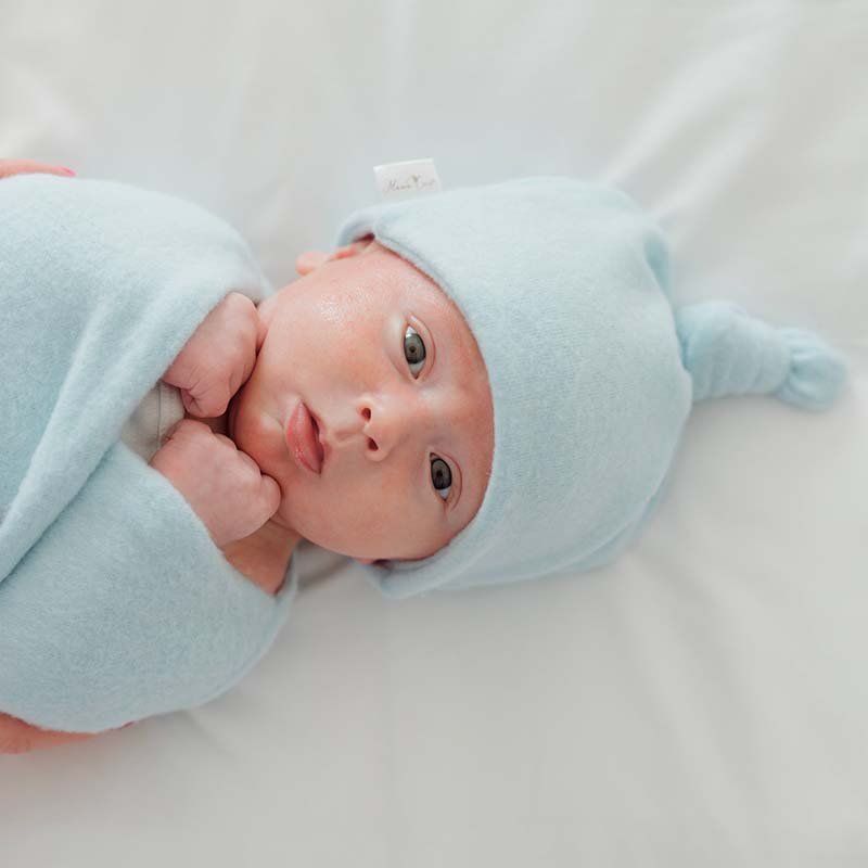 Knotty beanies crafted in soft Plush Powder Blue fabric.