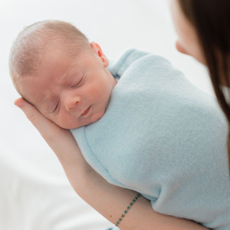 Reversible Baby Cocoon swaddle baby blanket in various fabric styles. 