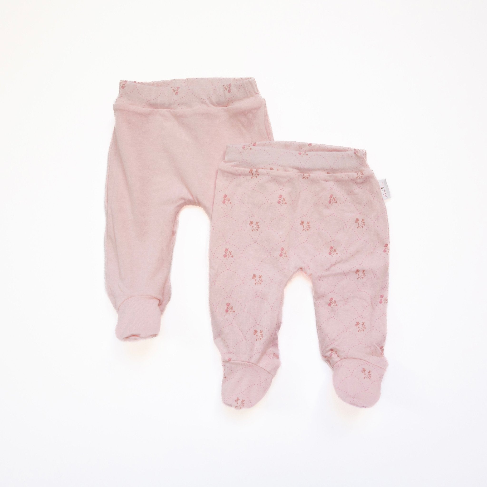 Reversible baby footie pants in dainty dots design.
