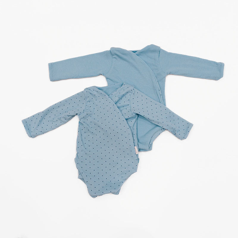 Reversible long sleeve silky modal onesie bodysuit in a dotted blue design.