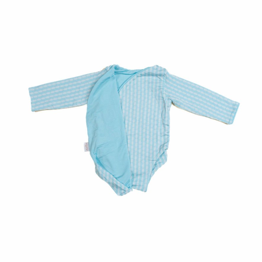 Reversible lil surfer design long-sleeve baby onesie in silky modal fabric.