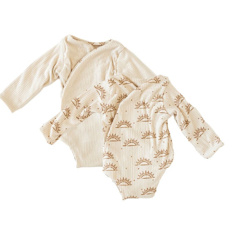 Reversible long-sleeve winged bodysuit in sandy sunsets design.