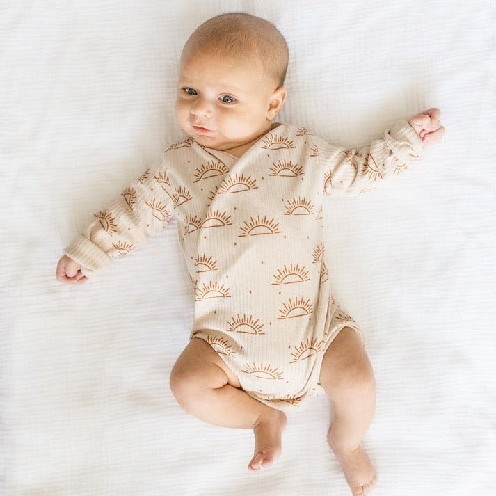 Reversible long-sleeve winged bodysuit in sandy sunsets design.
