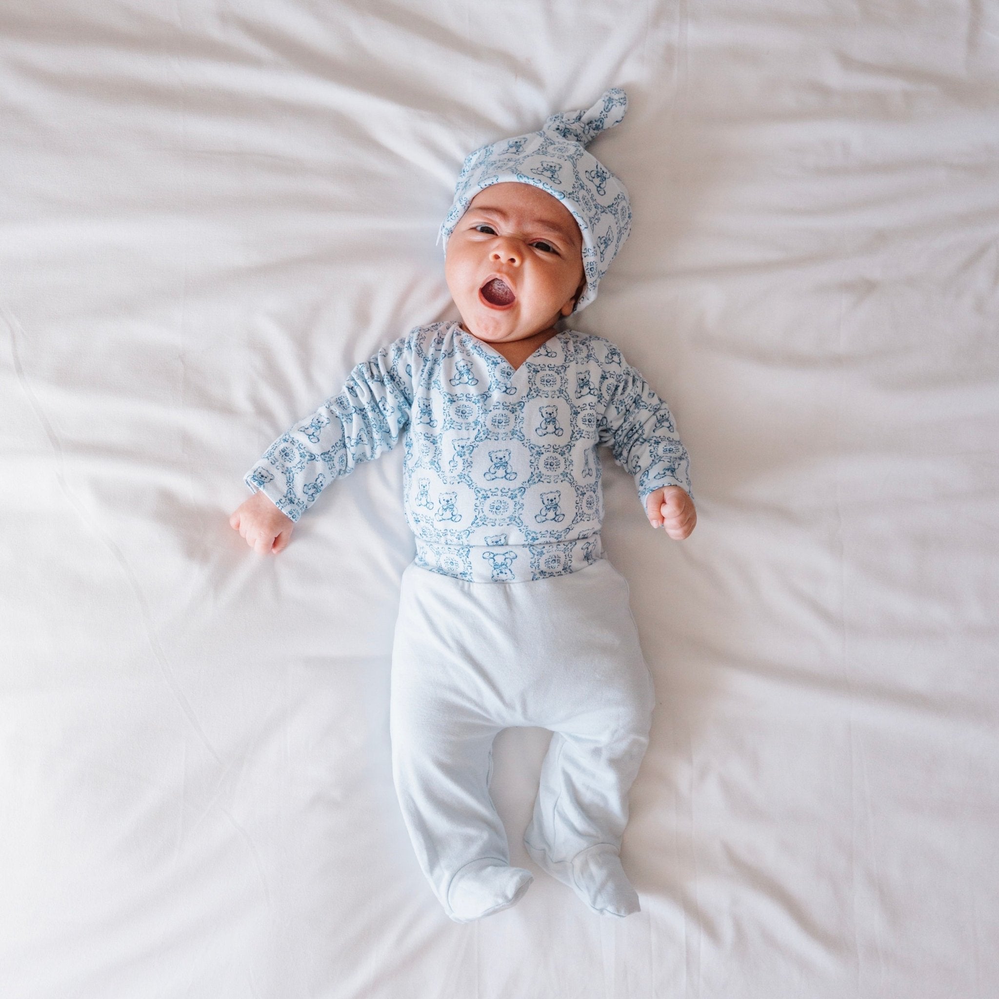 Reversible long-sleeve baby onesie outfit bundle made from bamboo cotton in teddy tiles design.