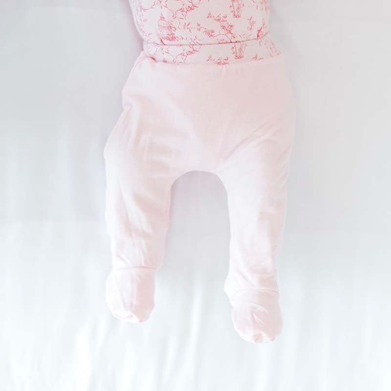 Reversible baby footie pants in whimsical garden design.