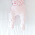 Reversible baby footie pants in whimsical garden design.