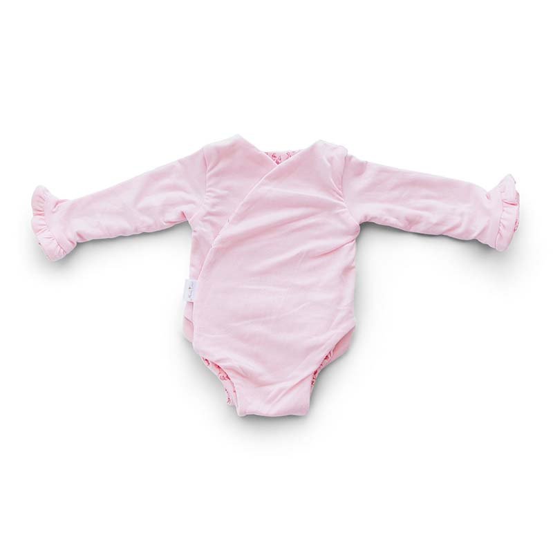 Reversible ruffle cuff long sleeve baby onesie made from bamboo cotton.
