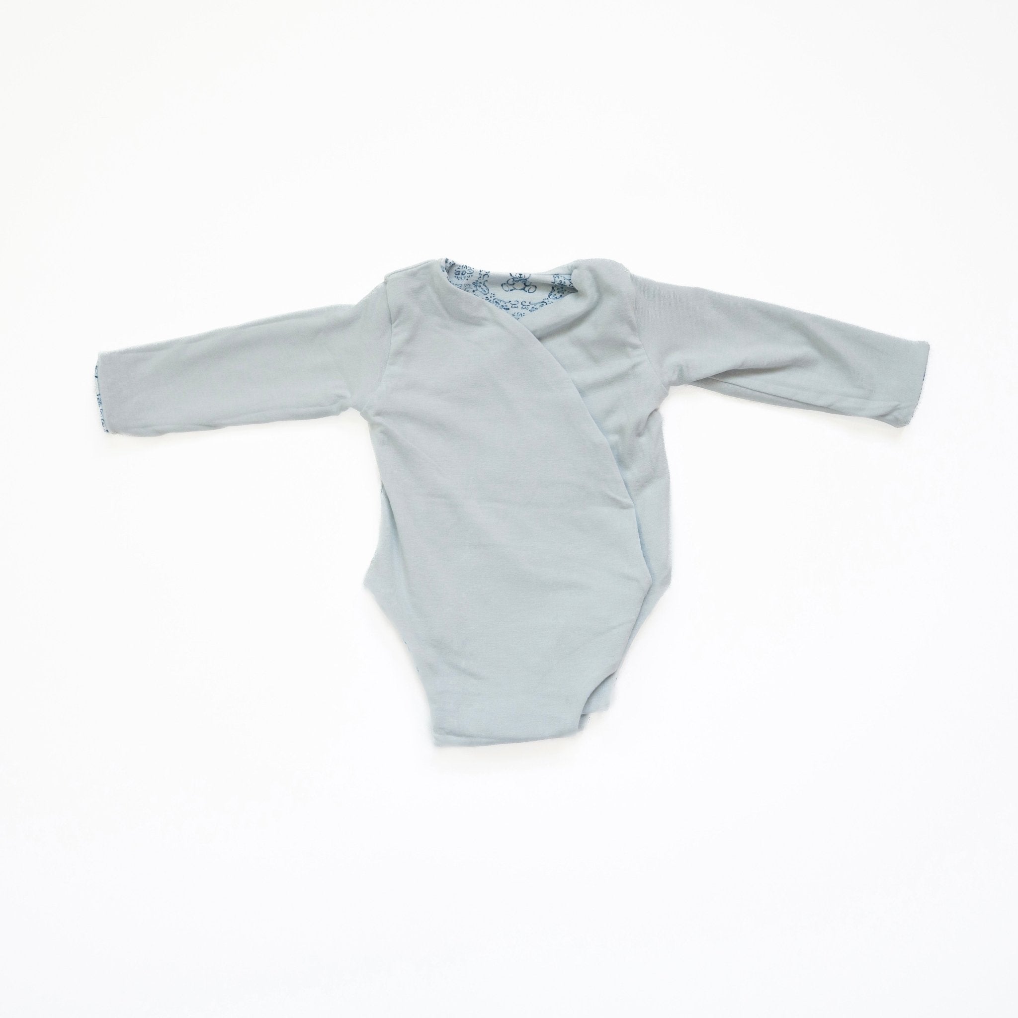 Reversible long-sleeve winged bodysuit for babies.