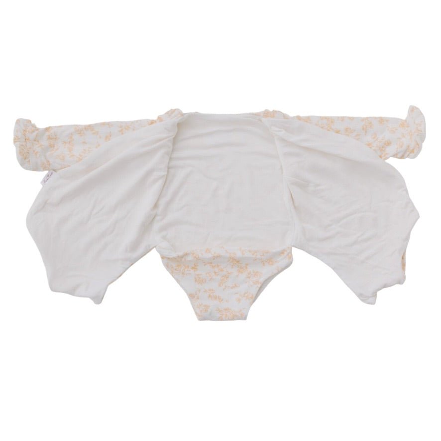 Reversible long sleeved winged bodysuit for babies in silky modal fabric with ruffle cuffs.