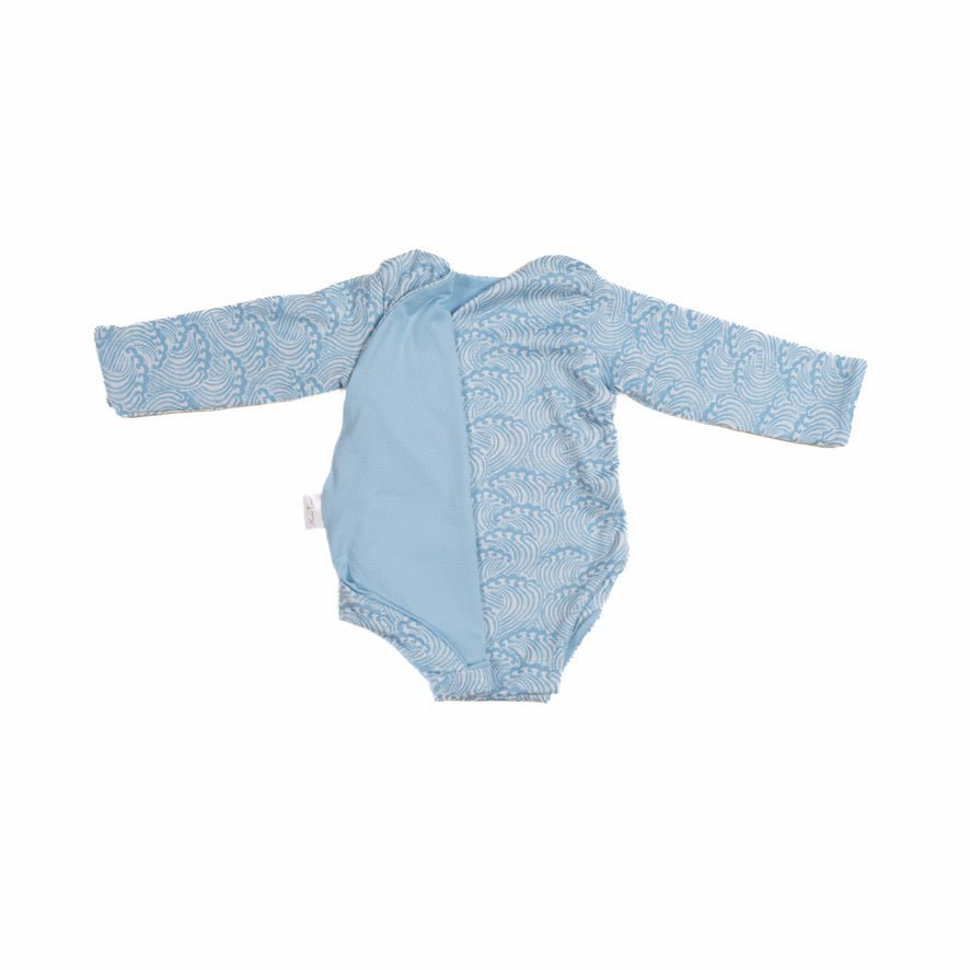 Reversible blue swells design long-sleeve baby onesie in classic brushed fabric.