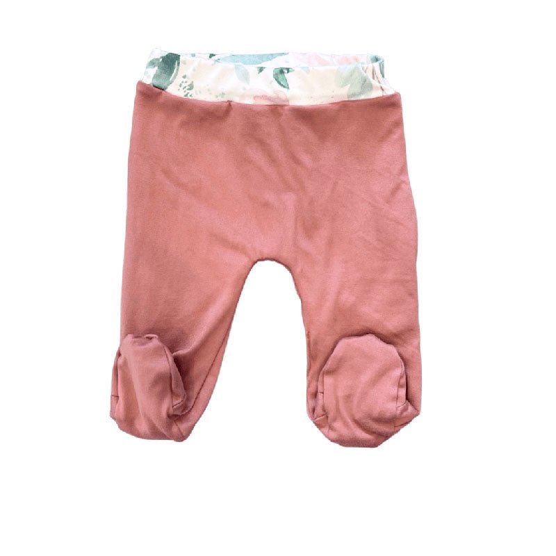 Reversible baby footie pants crafted from a soft silky and organic modal blend featuring the Blushing Eucalyptus print.