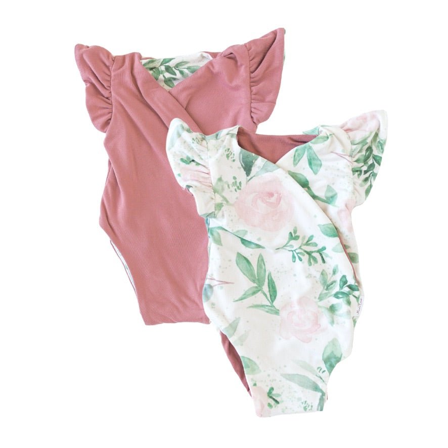 Reversible flutter sleeve baby onesie in blushing eucalyptus design.