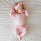 Soft and gentle baby footie pants made from silky modal fabric in the Baby Pink Gingham design.