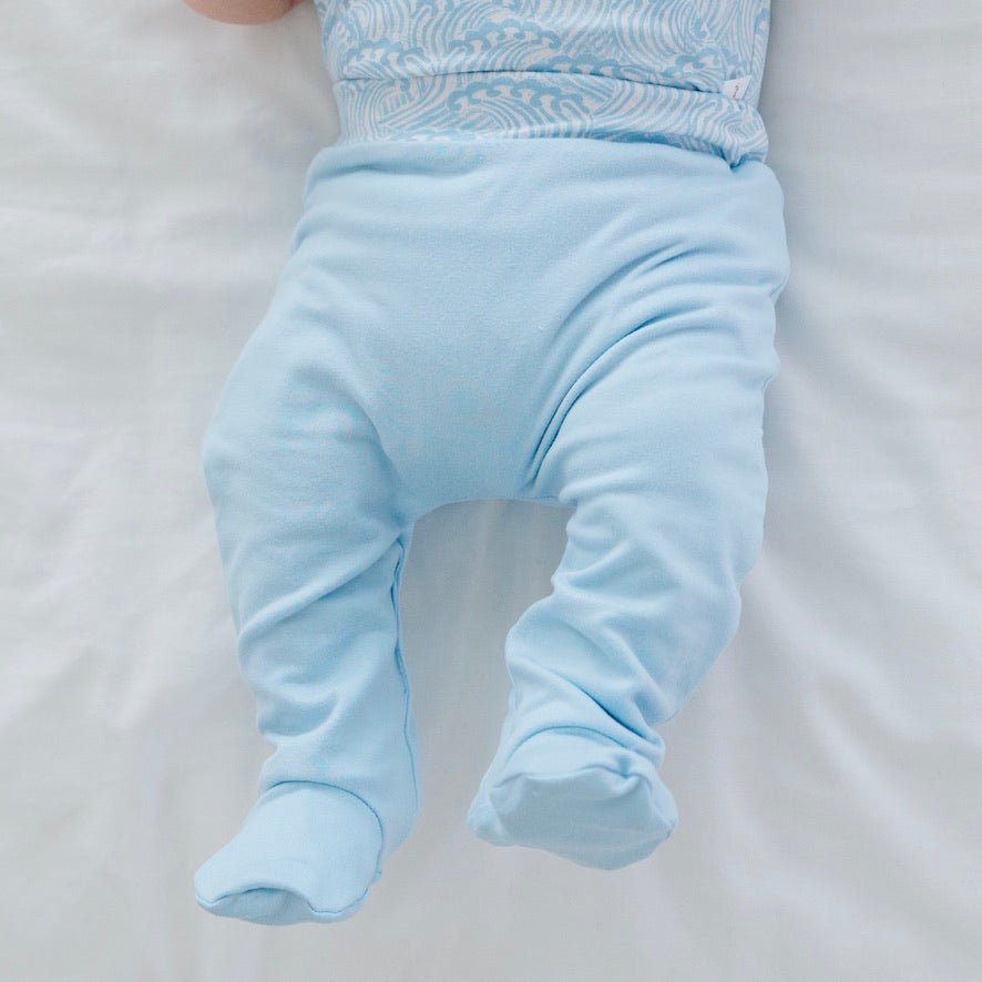 Reversible Blue Swells baby footie pants made with breathable bamboo cotton fabric.
