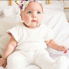 Reversible baby footie pants designed in bamboo cotton fabric featuring our Ivory Wildflowers design.