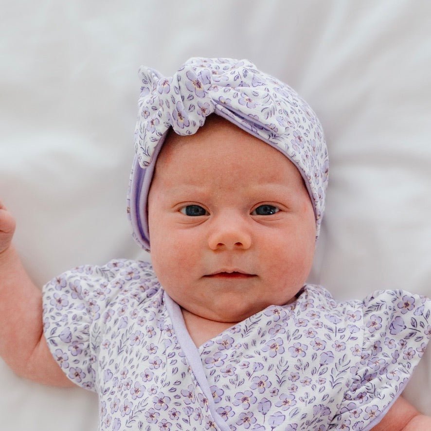 Baby knotty beanie in purple posies design.