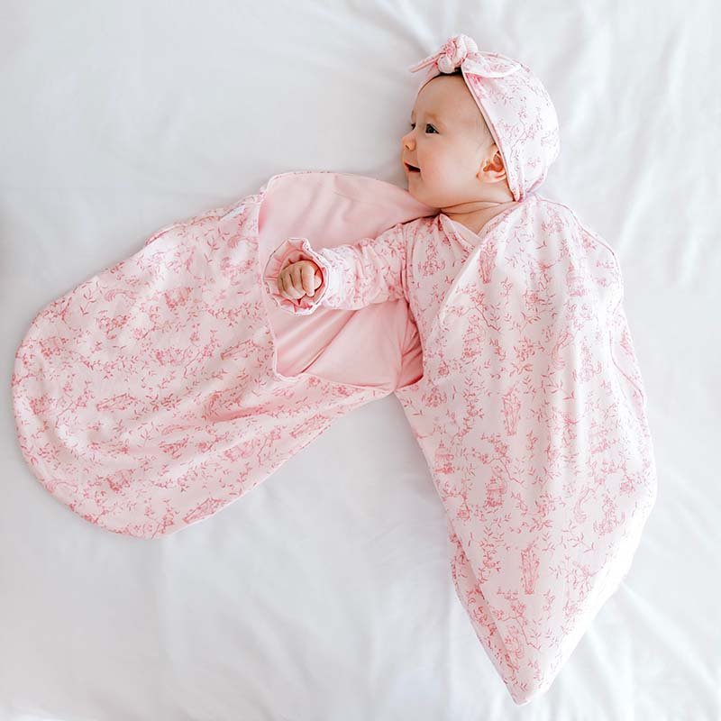 Reversible whimsical garden design newborn essentials bundle in bamboo cotton fabric.