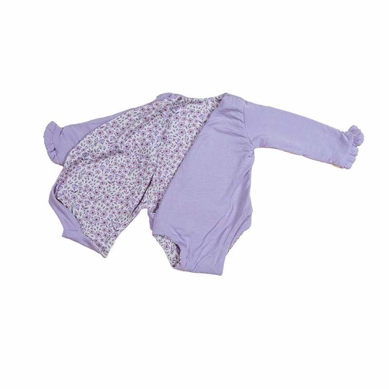 Reversible long sleeved winged bodysuit for babies in silky modal fabric with ruffle cuffs.