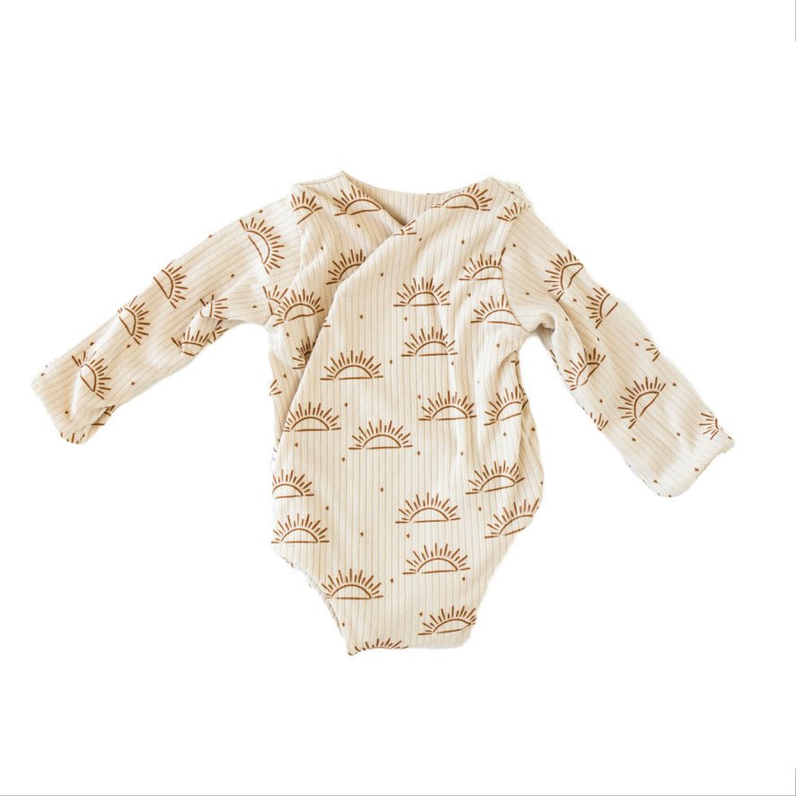 Reversible sandy sunsets design long-sleeve baby onesie in classic brushed fabric.