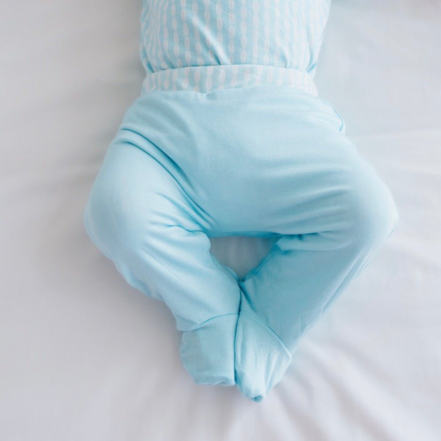 Soft and gentle reversible baby footie pants made from silky modal fabric in the Lil Surfer design.