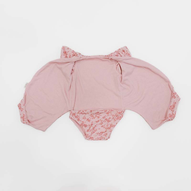 Reversible Bitty Pink Blooms design flutter sleeve winged bodysuit in silky modal fabric.