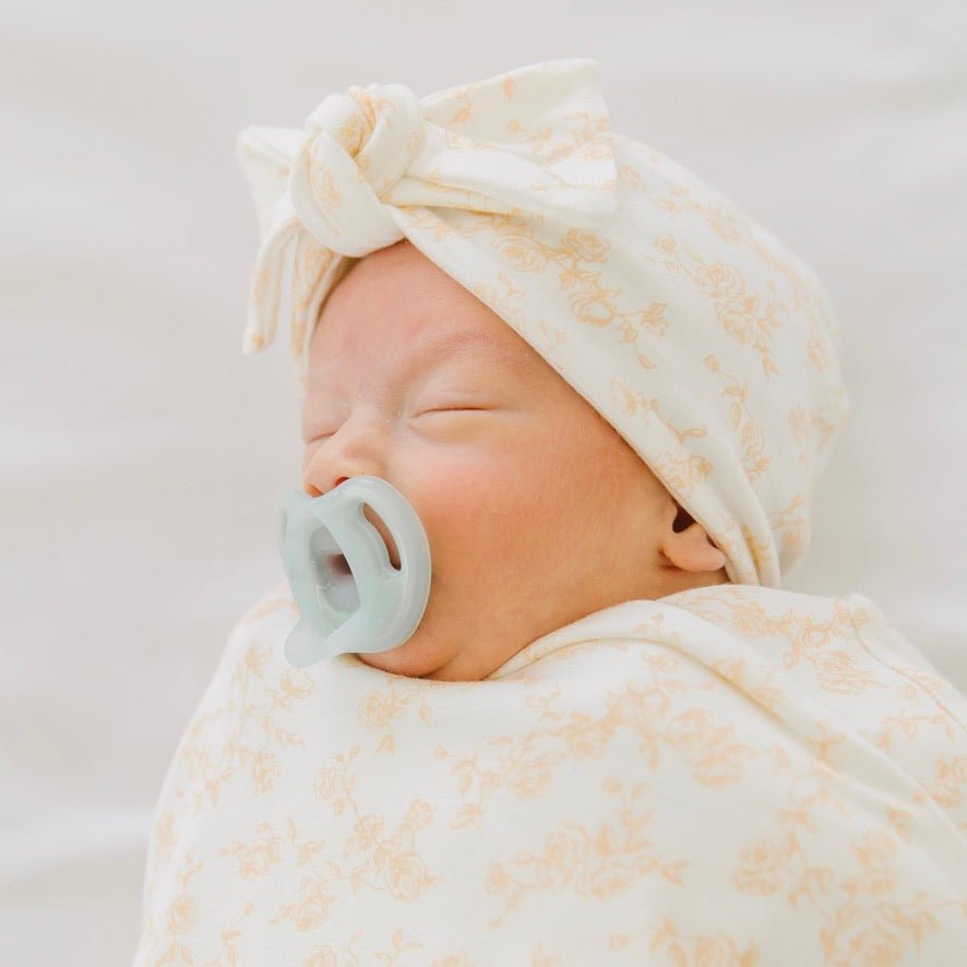 Ruched beanie with bow in Bitty Blooms design, made from Silky Modal fabric.