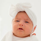Ruched beanie with bow crafted in soft Plush Perfection design Plush Dream fabric.