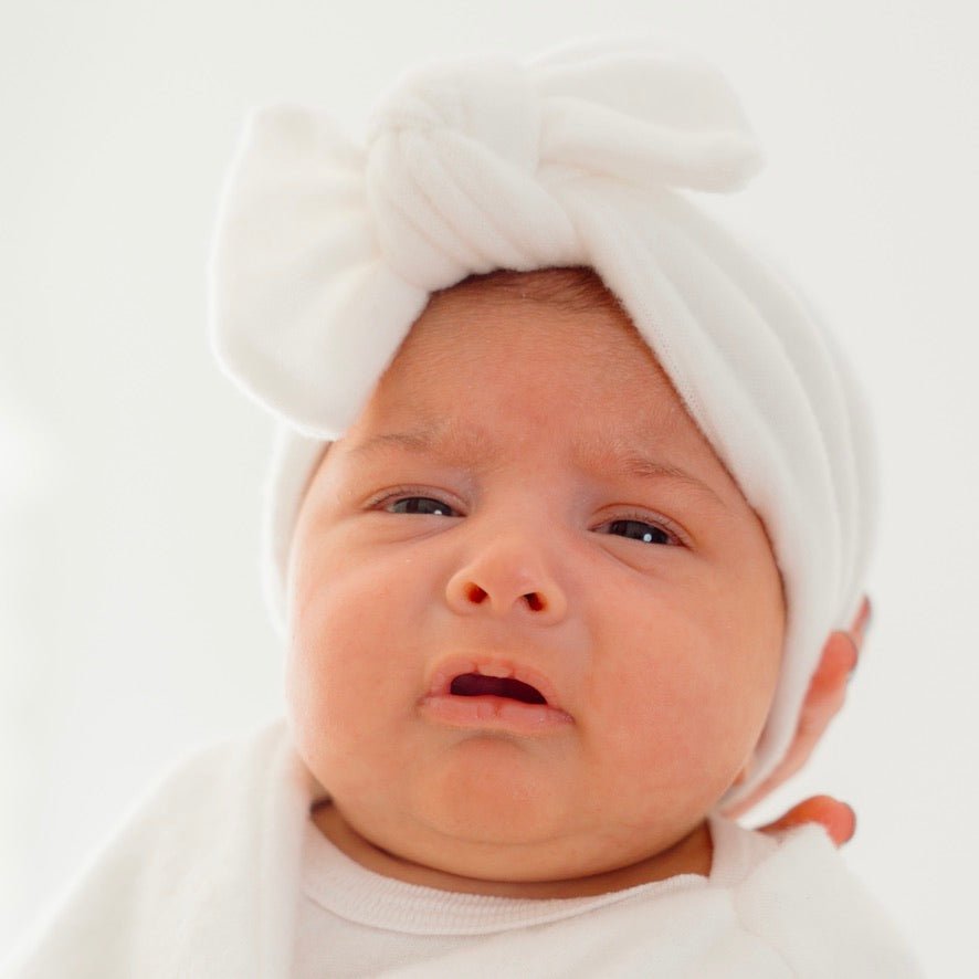 Ruched beanie with bow crafted in soft Plush Perfection design Plush Dream fabric.