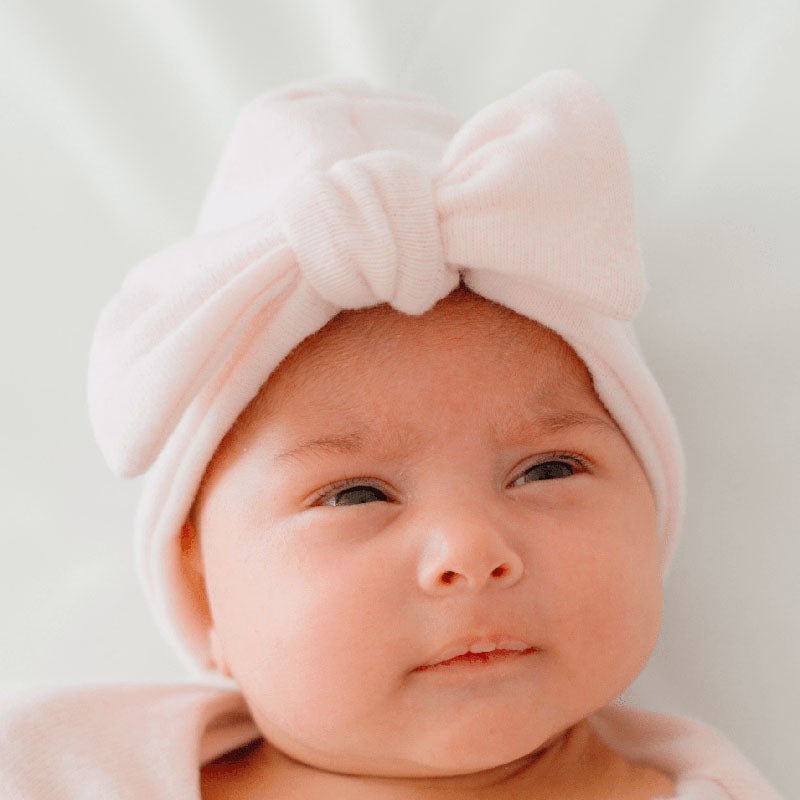 Ruched beanie with bow in Plush Pink Cashmere design, made from Plush Dream fabric.