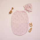 Bamboo cotton baby beanie with ruched bow in dainty dots design. Shown with matching cocoon swaddle.