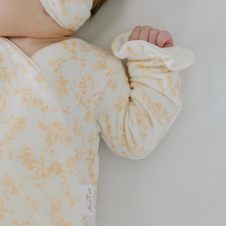 Long sleeved winged bodysuit for babies in silky modal fabric with ruffle cuffs.