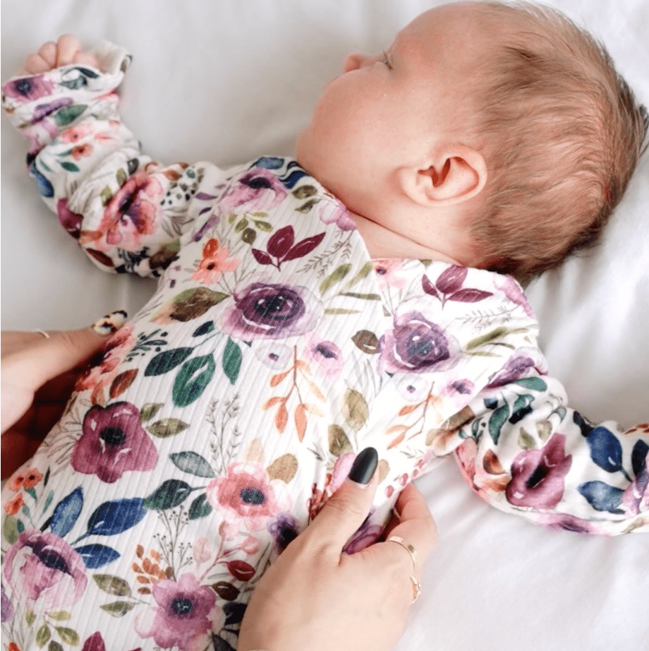Ivory wildflowers ruffle cuff long sleeve onesie.