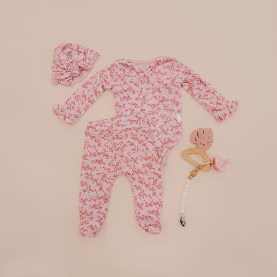 Ruffle cuff long sleeve baby onesie outfit bundle made from silky modal fabric in bitty pink blooms design.