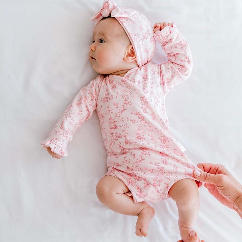 Whimsical garden ruffle cuff long sleeve baby onesie outfit bundle made from bamboo cotton.