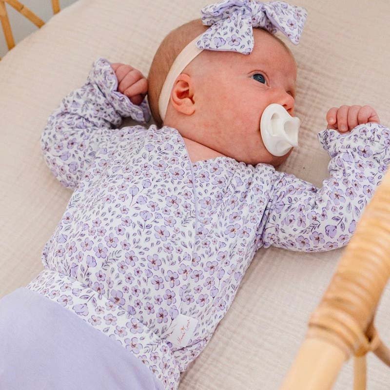 Purple Posies design ruffle cuff baby winged bodysuit in silky modal fabric.