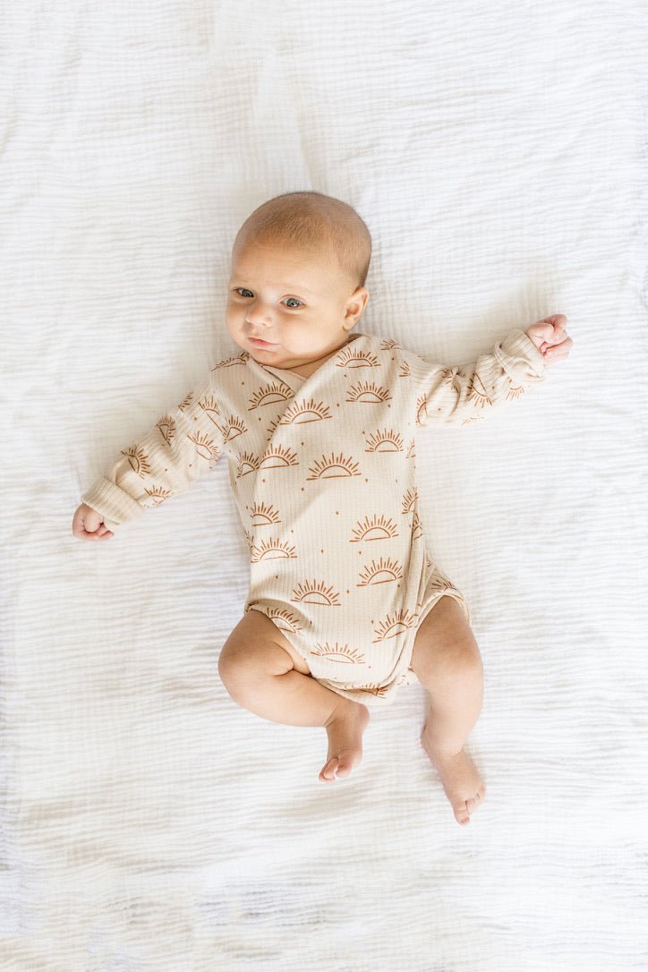 Sandy sunsets design long-sleeve baby onesie in classic brushed fabric.