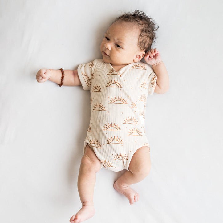 Sandy sunsets design short-sleeve baby onesie in classic brushed fabric.