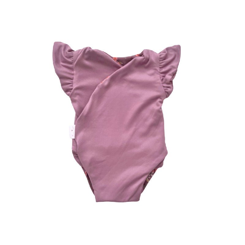 Reversible Peachy Lilac short-sleeve baby bodysuit in Classic Brushed fabric styles.