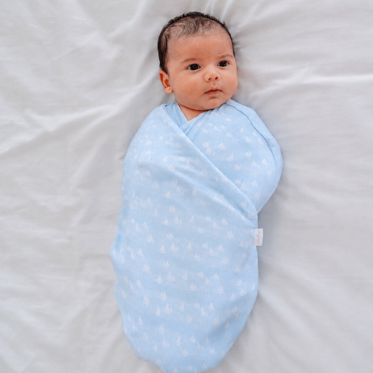 Soft baby cocoon swaddle made from Silky Modal in the Sailboat Shores design.
