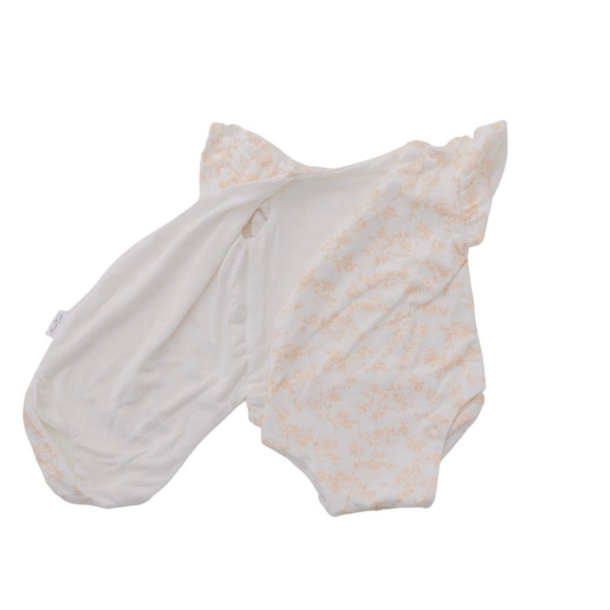 Reversible flutter sleeve baby onesie in Bitty Blooms design.