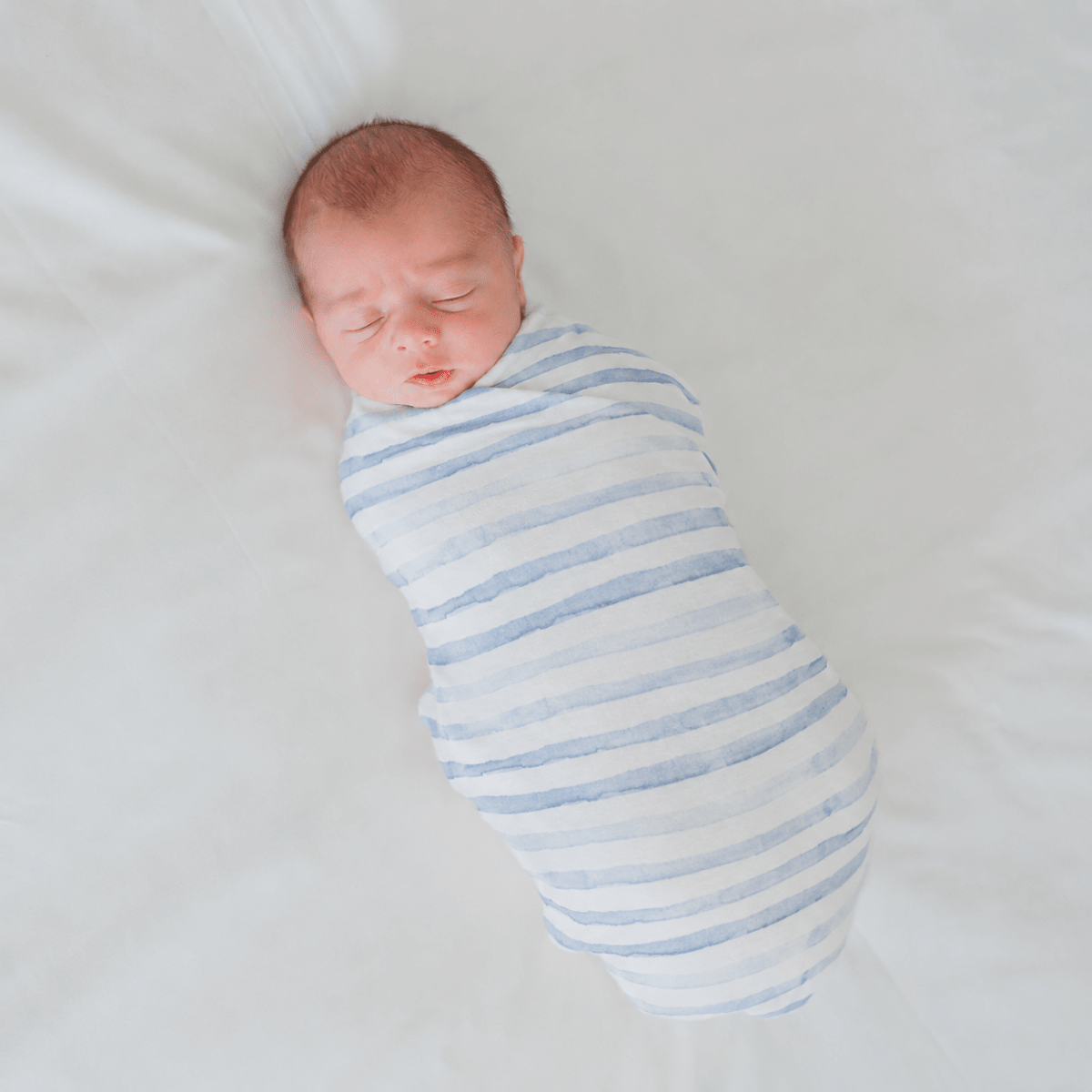 Soft baby cocoon swaddle made from Silky Modal in the Chambray Waves design.