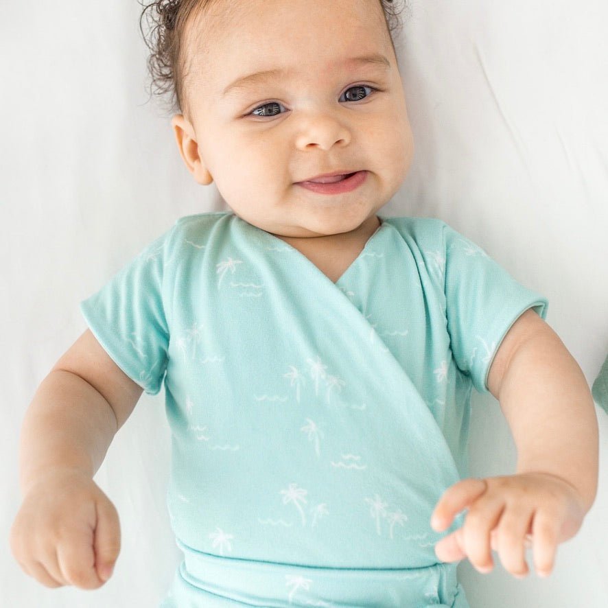 Short-sleeve winged bodysuit featuring the Honeydew Palms print in cozy classic brushed fabric.