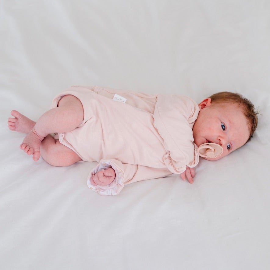 Comfortable Sweet Lily design brushed fabric reversible baby bodysuit with wings and ruffle trim cuffs.