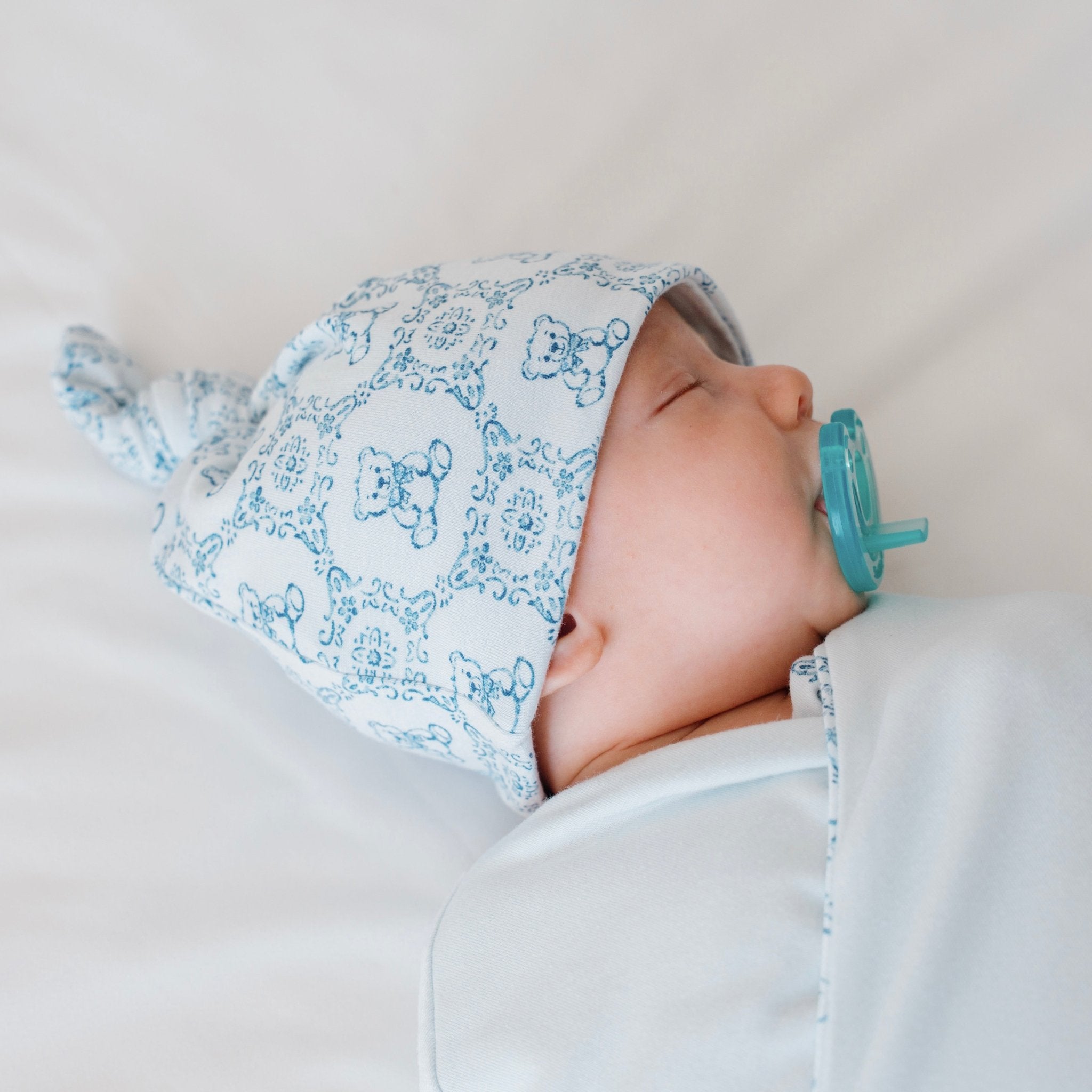 Reversible bamboo cotton baby knotty beanie in teddy tiles design.