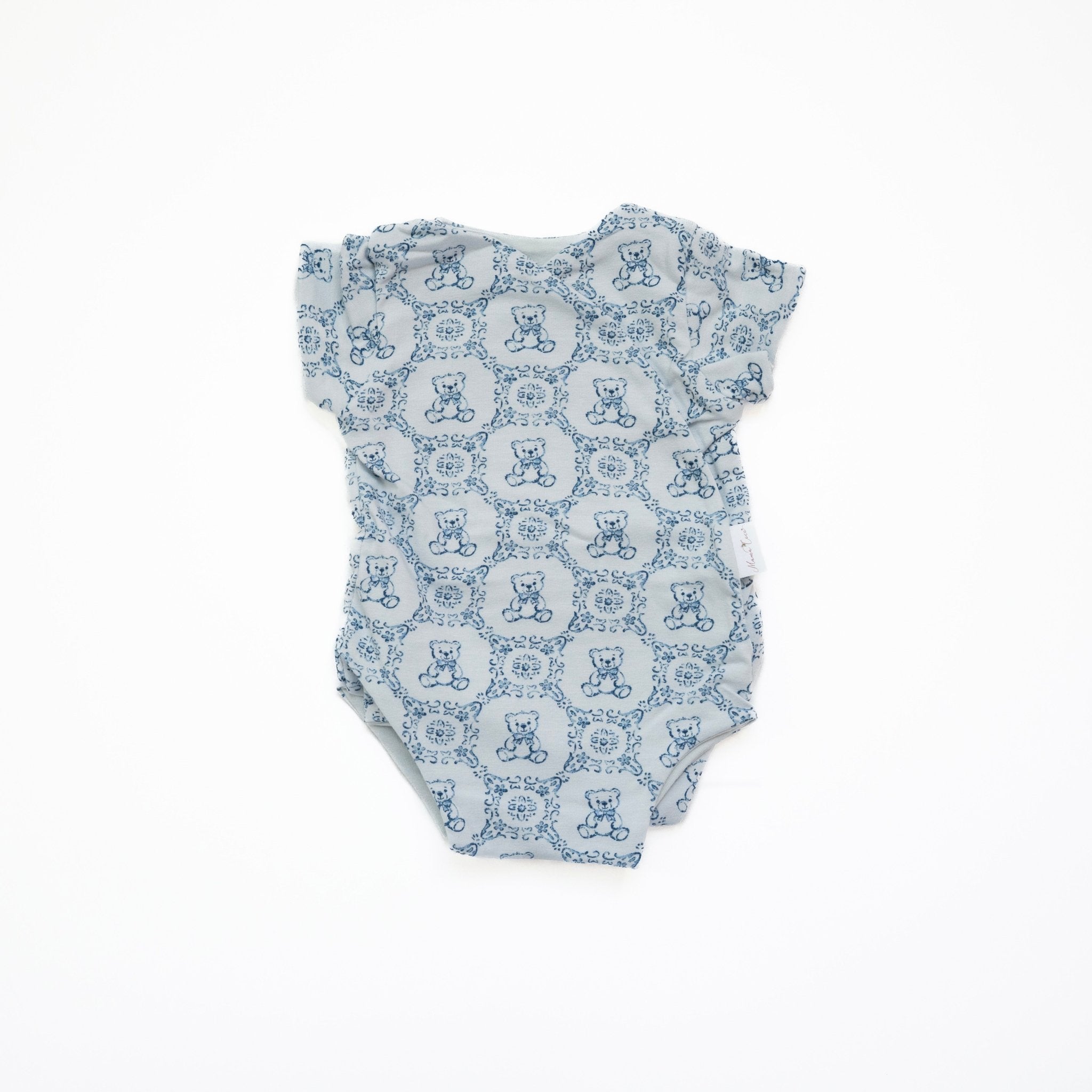 Reversible short-sleeve baby onesie in teddy tiles design.