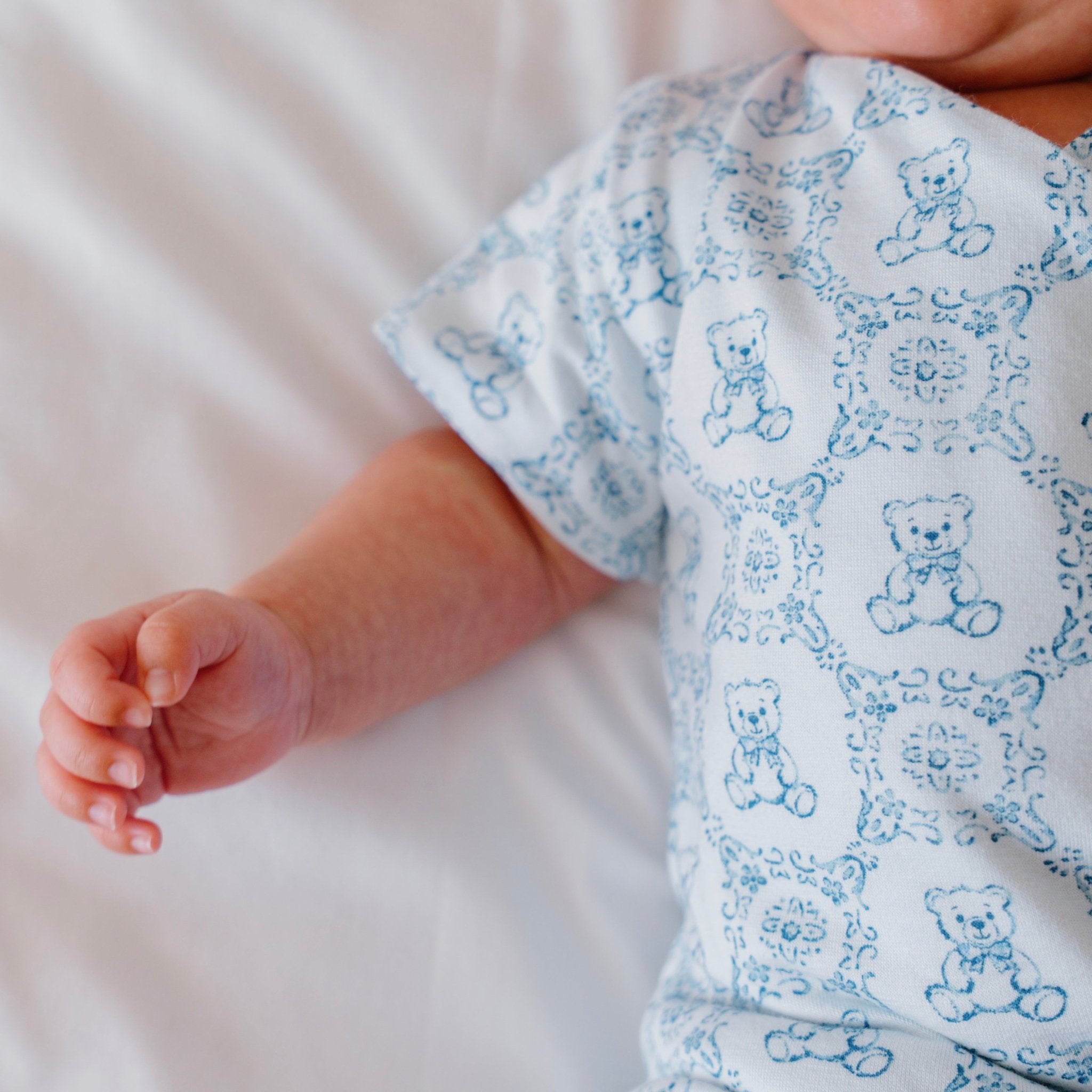 Reversible short-sleeve baby onesie in teddy tiles design.