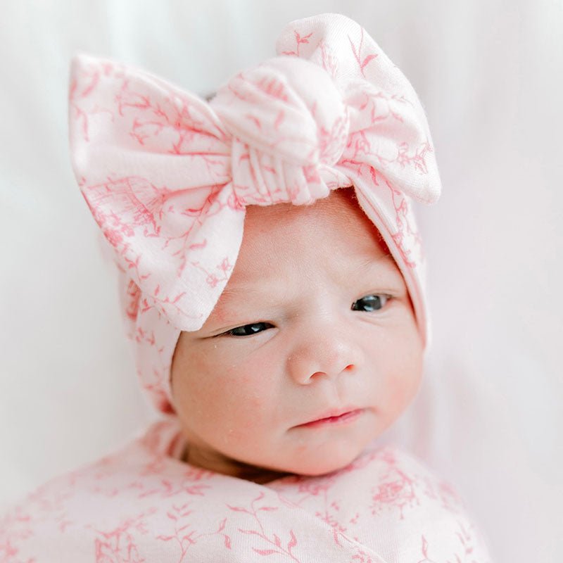 Sweet bow headwrap for babies made from soft bamboo and organic cotton fabric in a whimsical garden print.